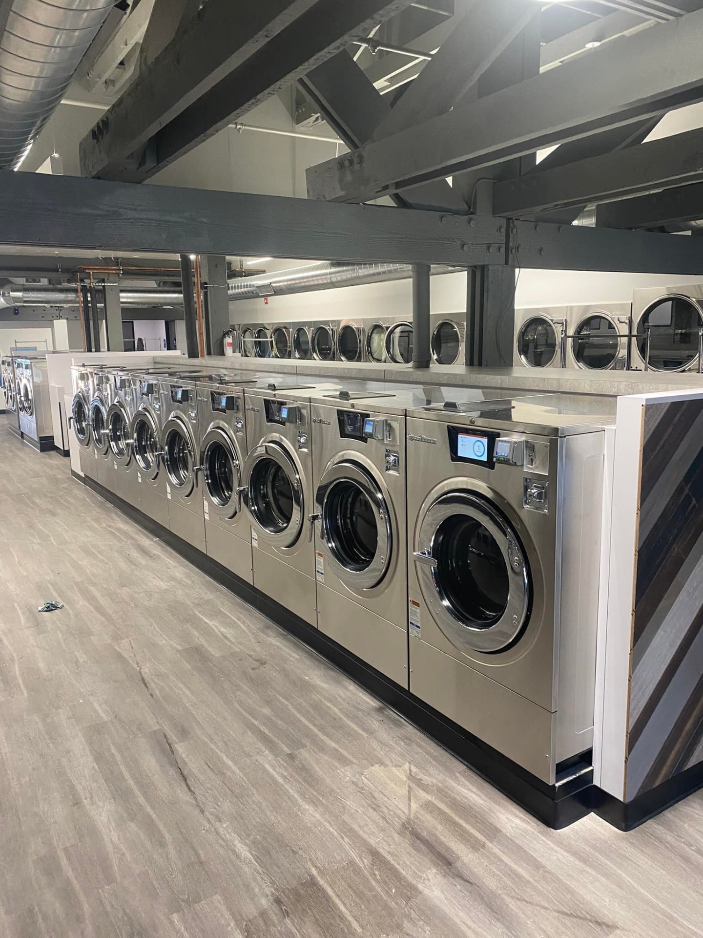 Commercial Speed Queen washers installed in a modern laundromat