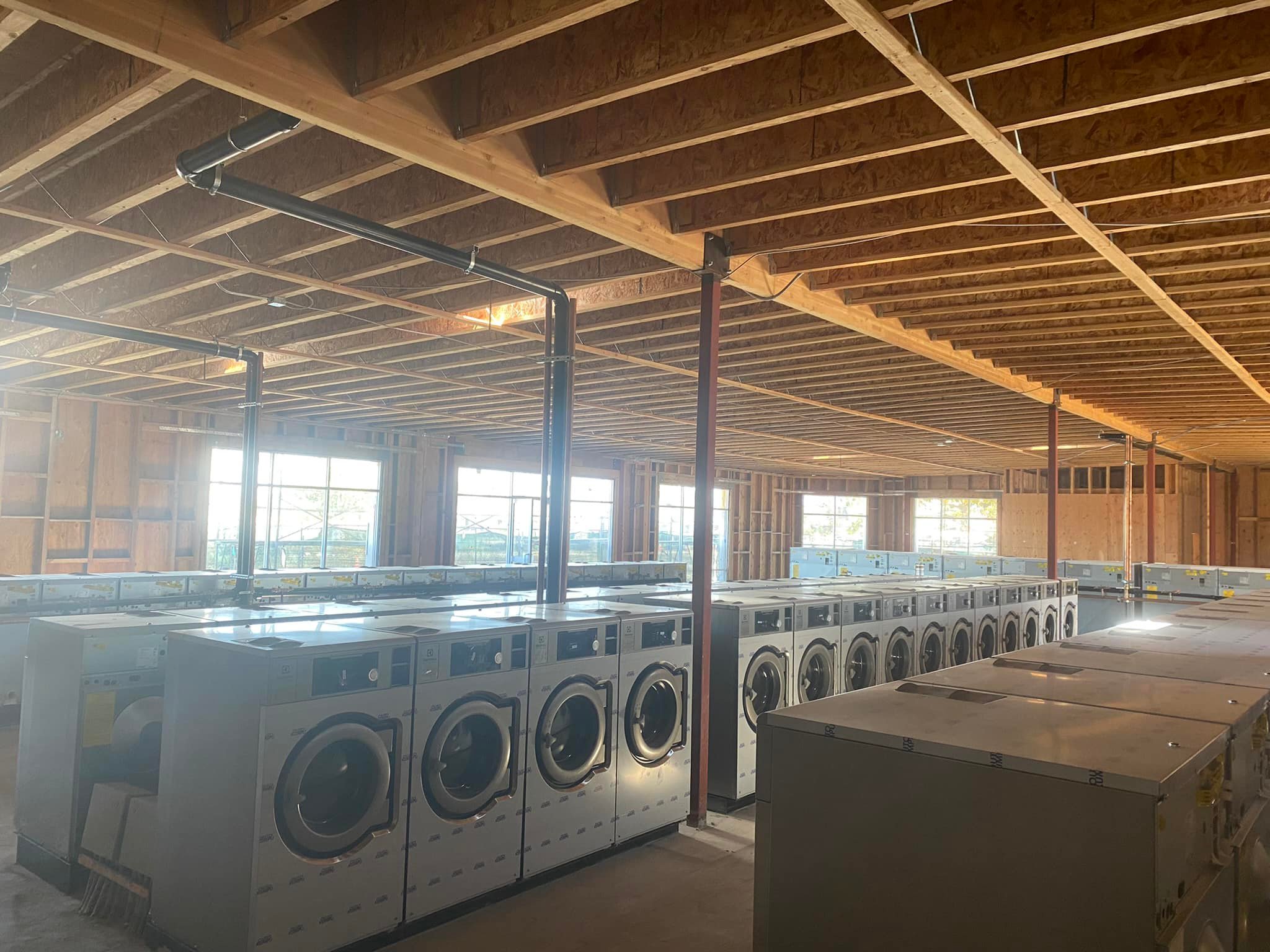 Commercial laundry equipment rows during installation