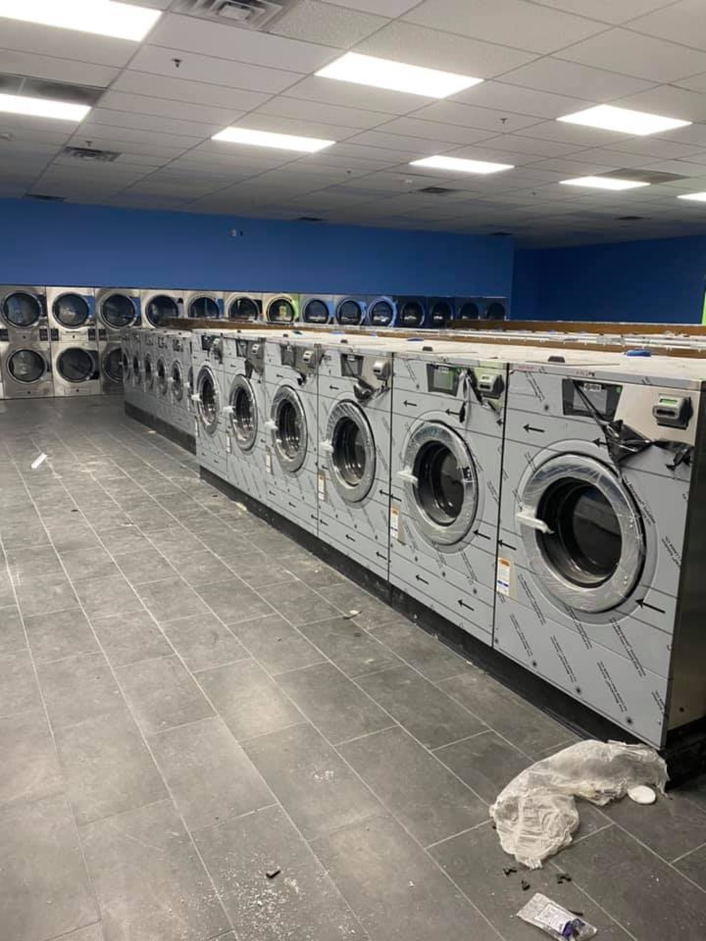 New commercial washers being installed in a renovation
